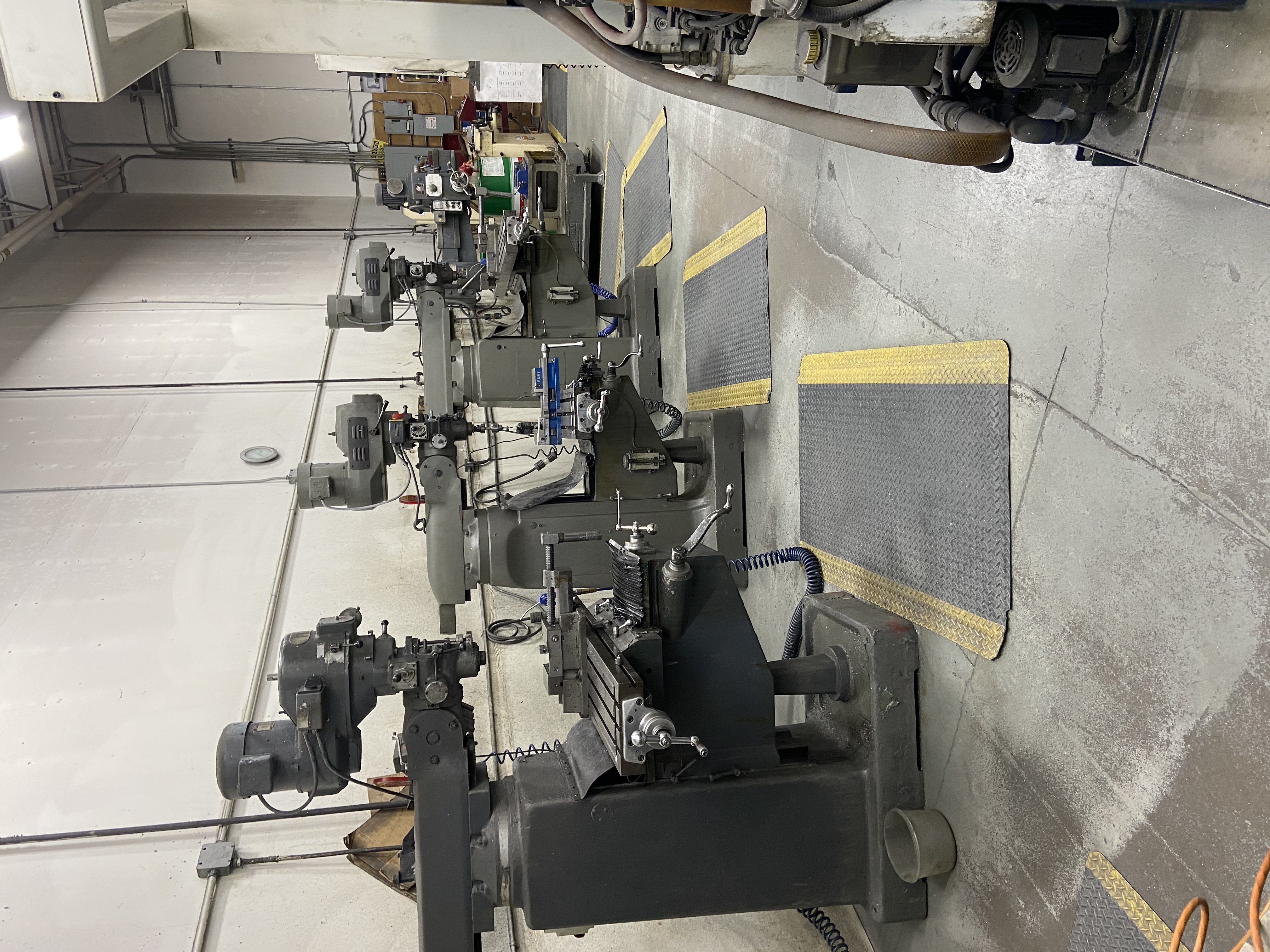 Row of manual milling machines on the shop floor